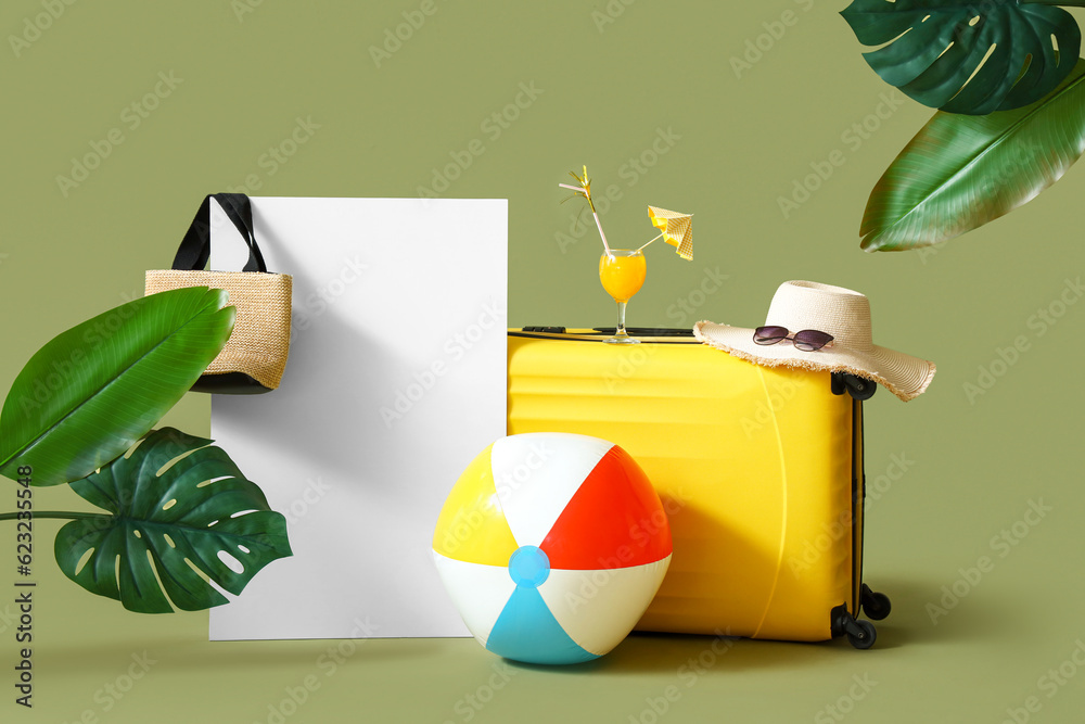 Blank poster with suitcase, cocktail and beach accessories on green background. Travel concept