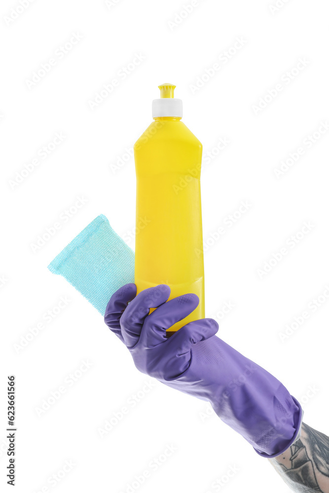 Young tattooed man with bottle of detergent and sponge on white background