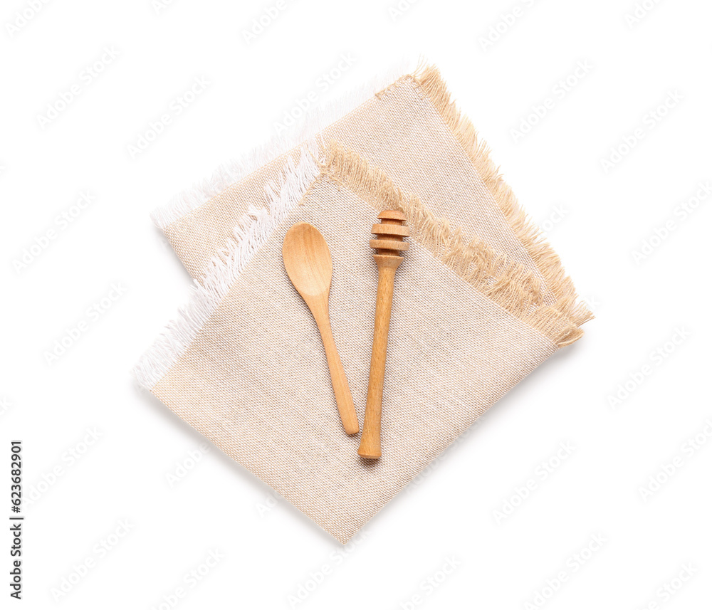 Clean napkin, wooden spoon and honey dipper on white background