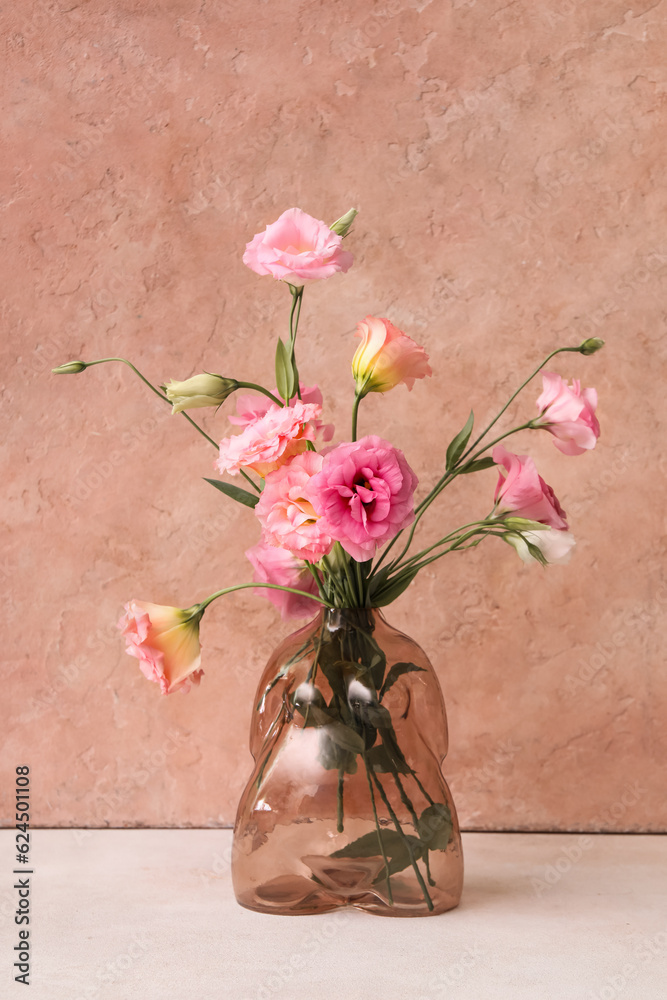 Vase with beautiful pink eustoma flowers on light table