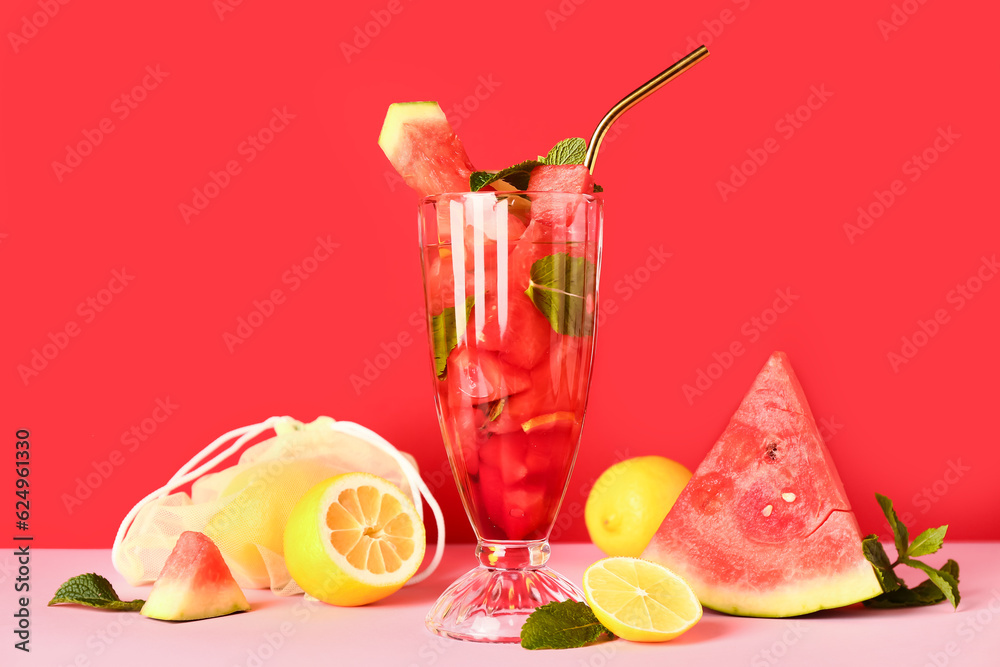 Glass of fresh watermelon lemonade with mint on pink table