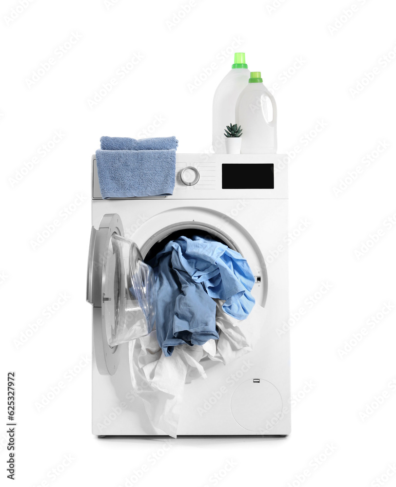 Opened washing machine with dirty laundry, towel and bottles of detergent isolated on white backgrou