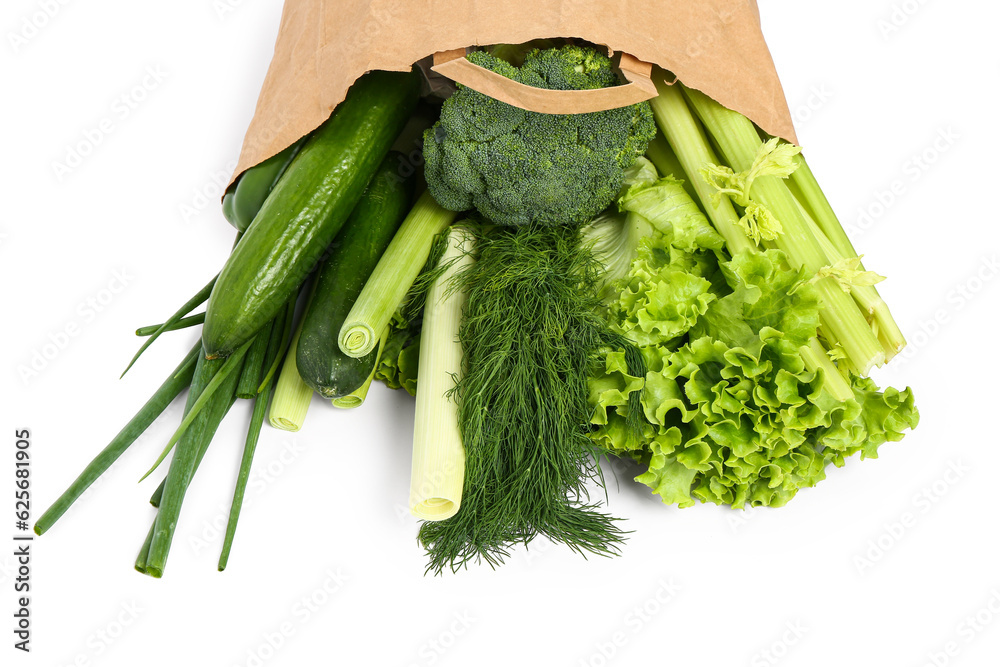 Paper bag with fresh vegetables on white background. Healthy food concept
