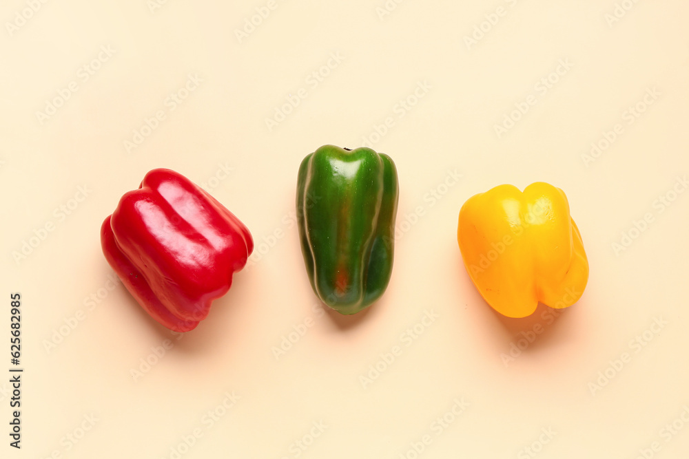 Colorful bell peppers on yellow background