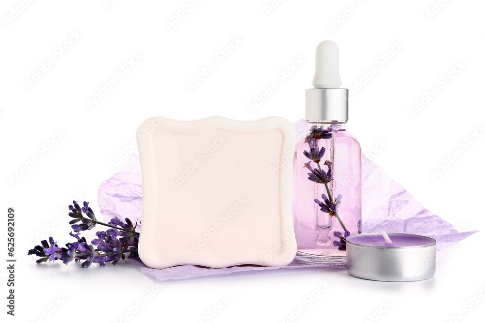 Lavender essential oil, soap bar and candle on white background
