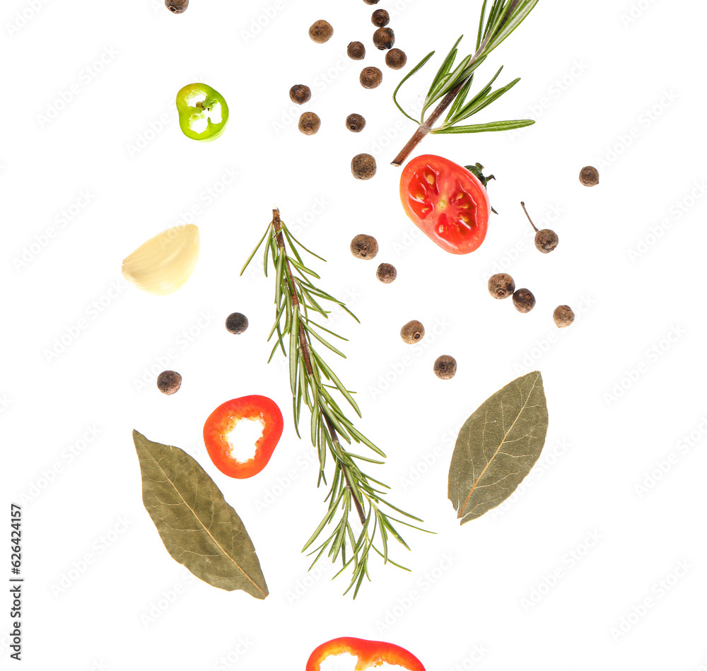 Flying aromatic spices and herbs on white background