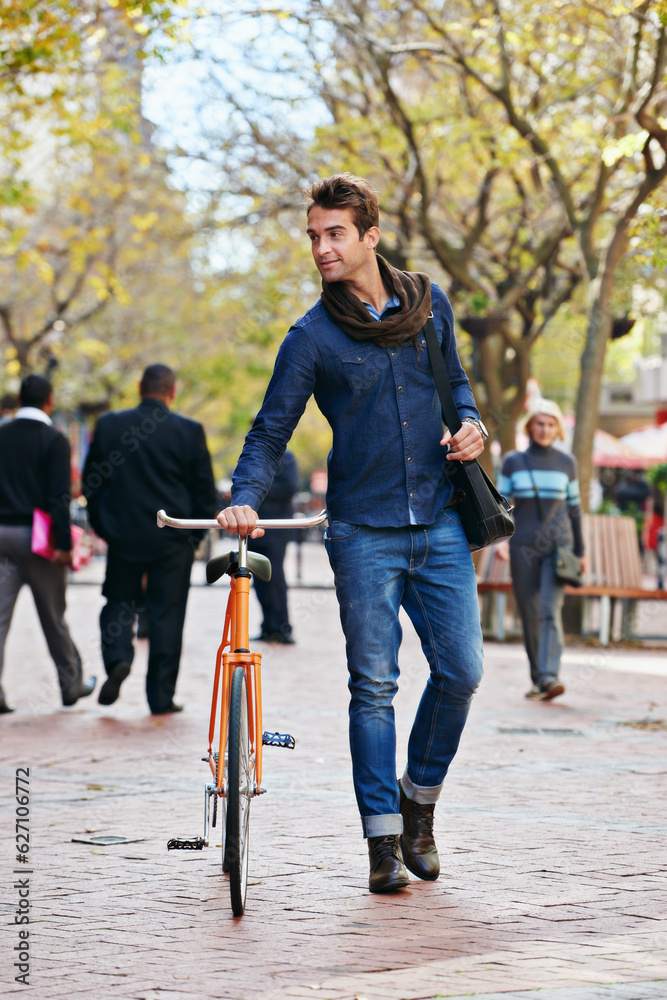 Getting around the green way. Full length shot of a handsome man in the city with his bicycle.