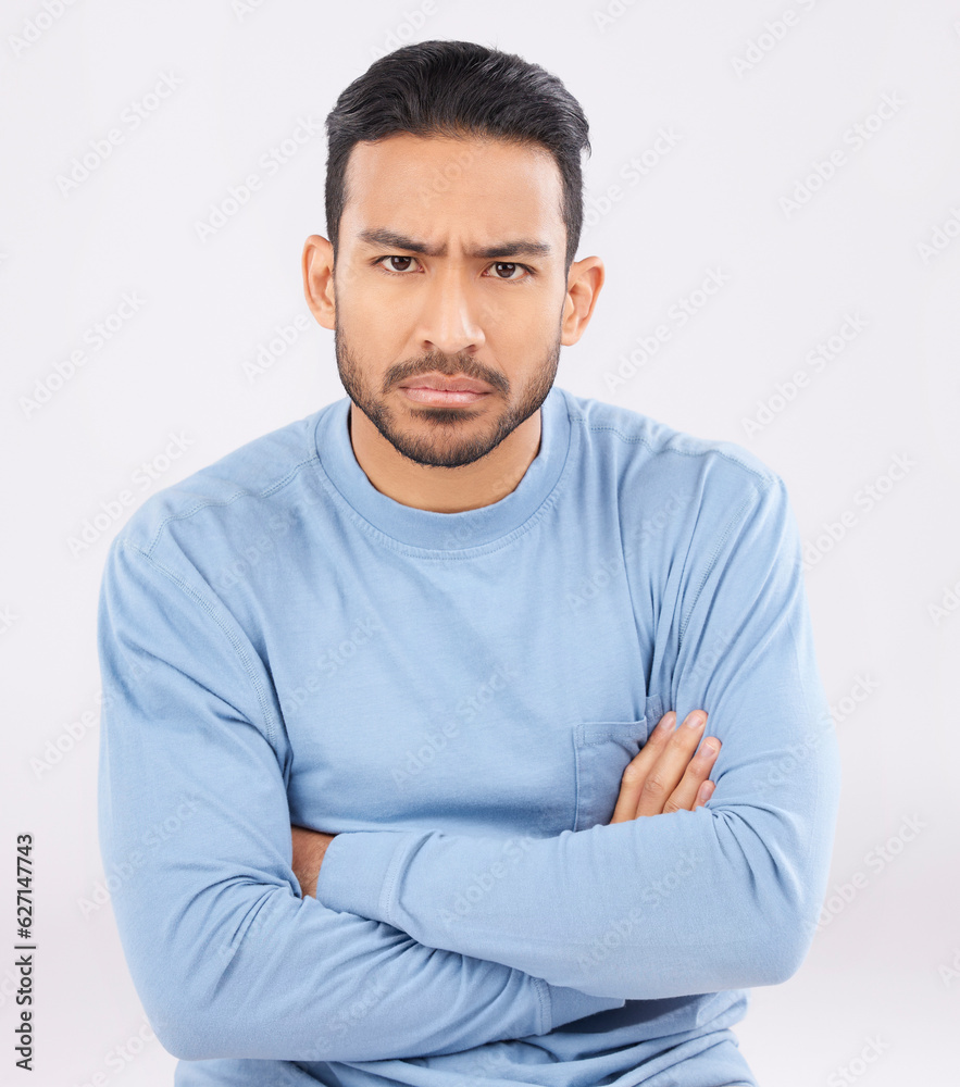 Portrait, angry and man with arms crossed, frustrated and upset guy against a white studio backgroun