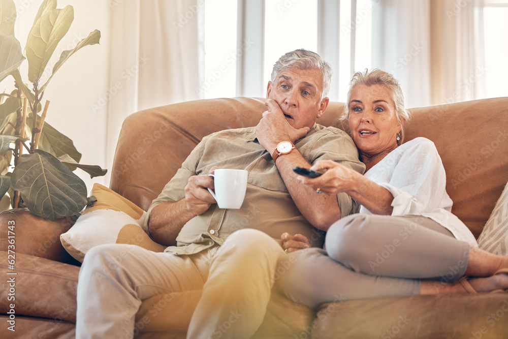 Senior couple, watching tv and sofa in relax for streaming, movie or series in living room at home. 