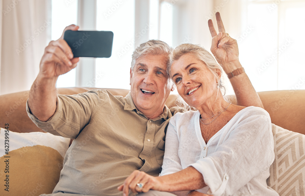 Happy senior couple, peace sign and selfie in relax on living room sofa for photograph, memory or vl