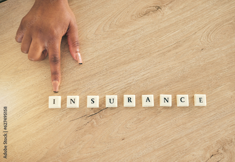 Insurance, above and hand pointing at blocks or word on a wooden table as a emergency or accident me