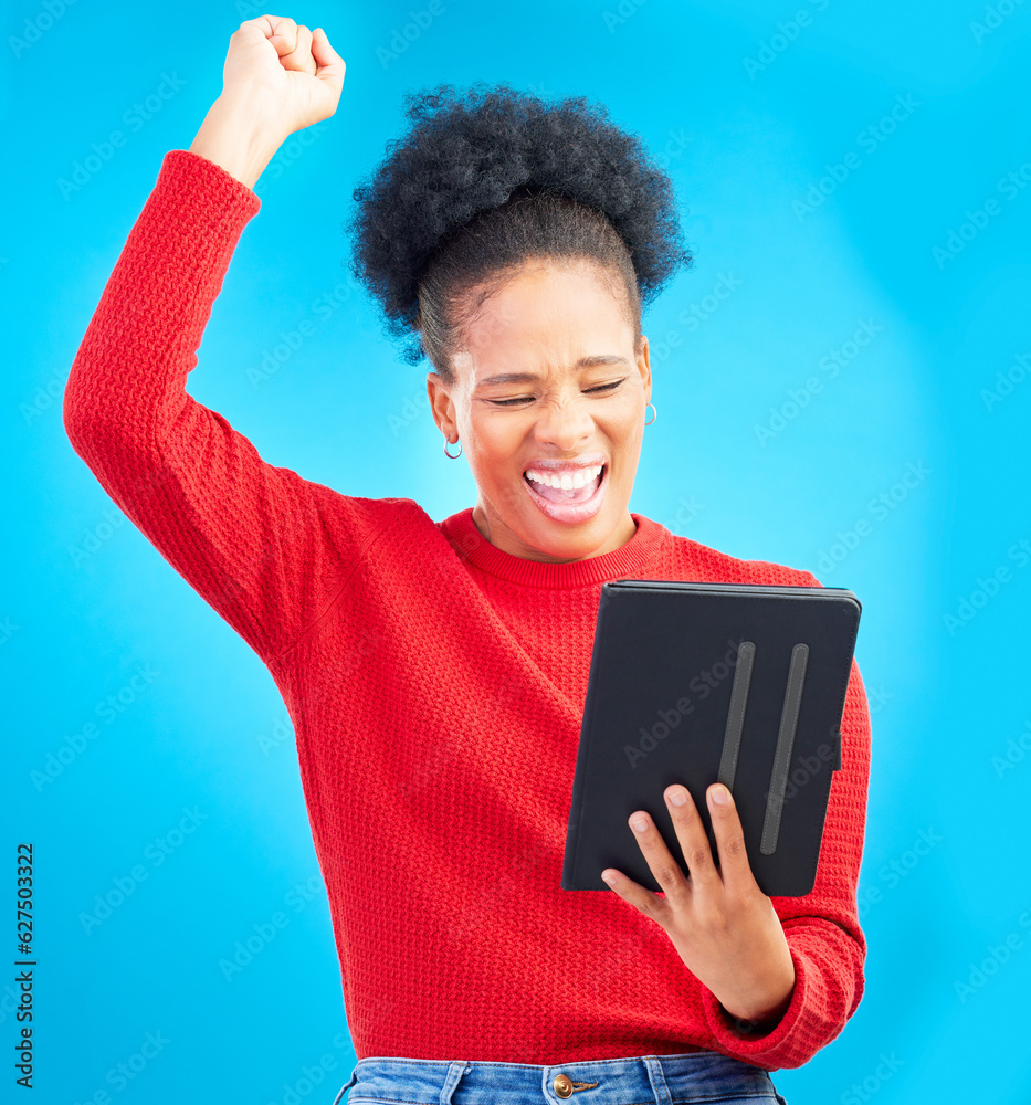 Happy woman, tablet and fist pump for winning, discount or sale against a blue studio background. Ex