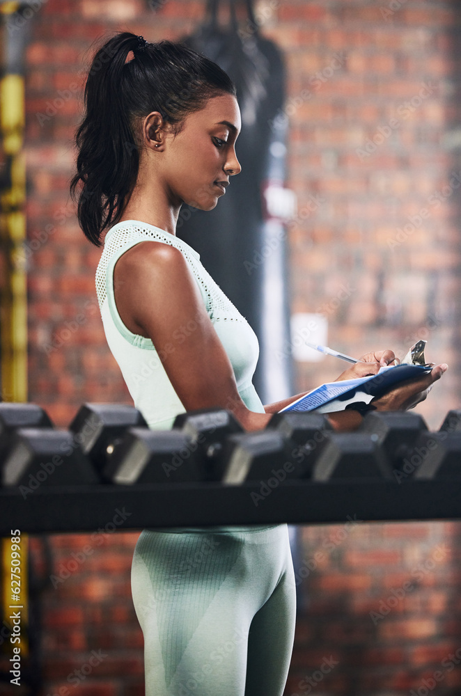 Personal trainer, gym or woman writing dumbbells or checking weights info for inspection checklist. 