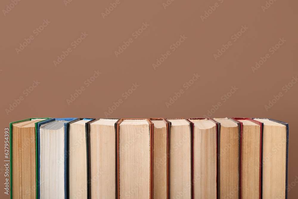 Row of books on brown background