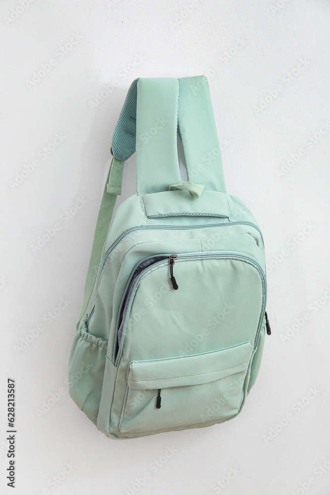 Green school backpack on white background