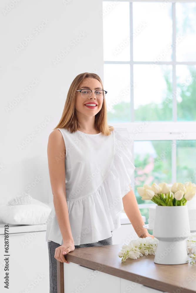Female wedding planner working with flowers in office
