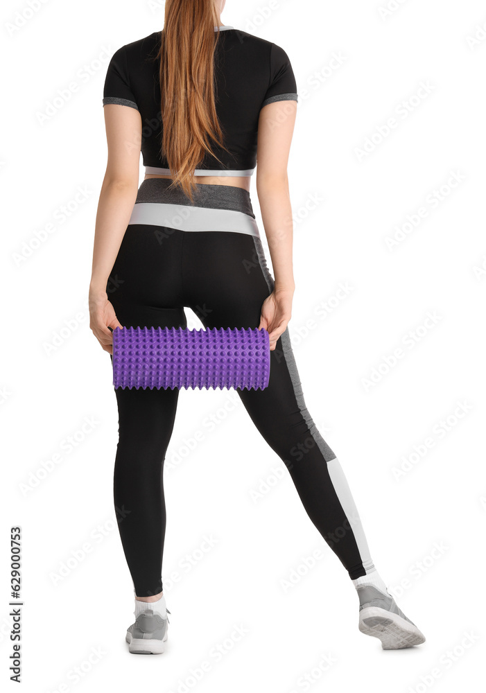 Young woman in sportswear and with foam roller on white background, back view