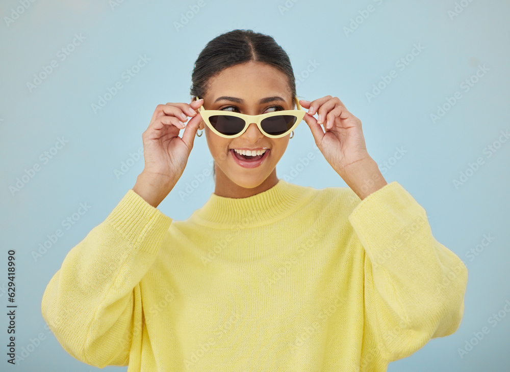 Happy, sunglasses and young woman in a studio with a casual, stylish and cool sweater outfit. Happin