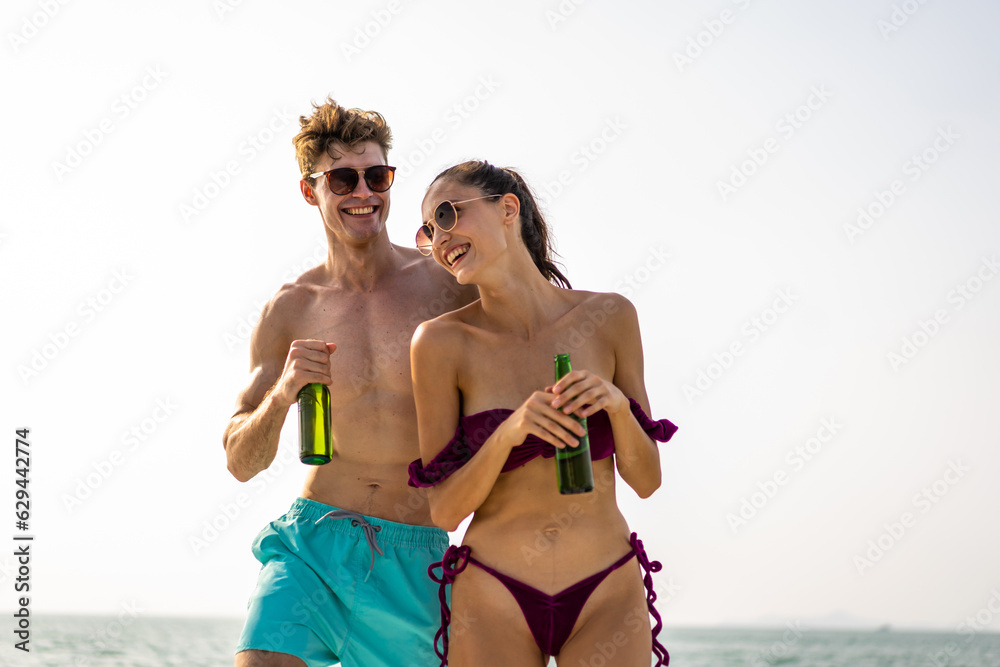 Caucasian young couple drink a bottle of beer, having party in yacht. 