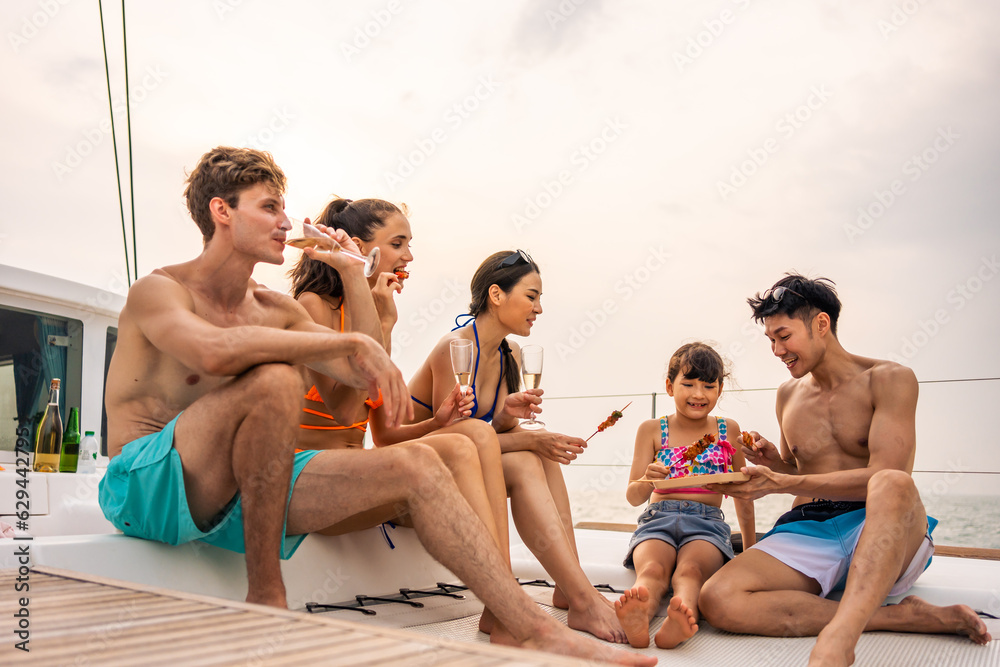 Group of diverse friends eating barbecue while having a party in yacht. 