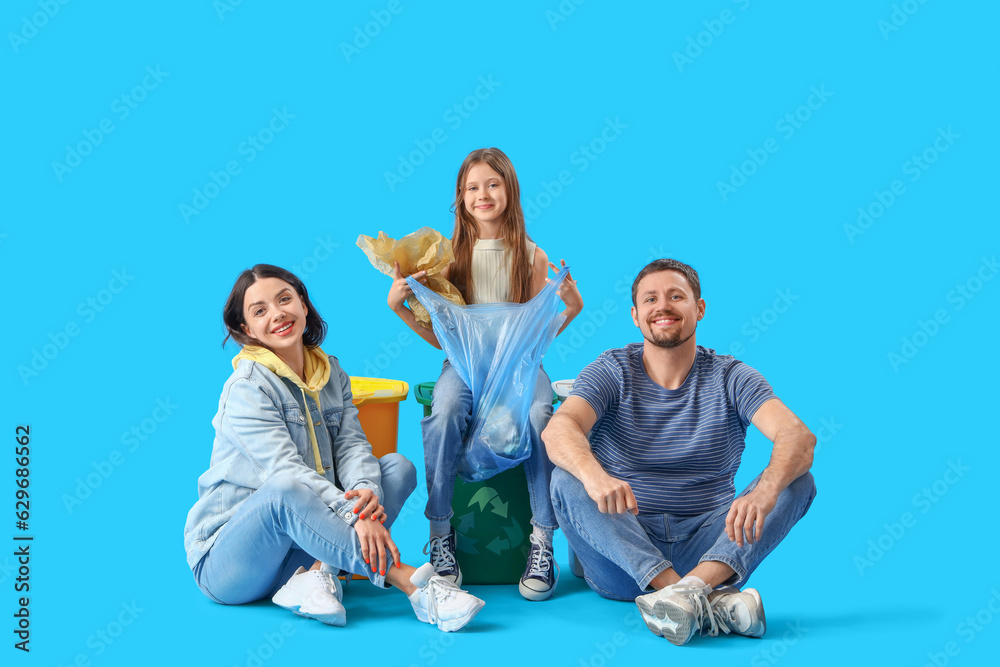 Family sorting garbage with recycle bins on blue background
