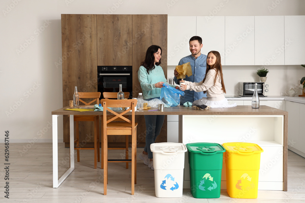 Family sorting garbage in kitchen
