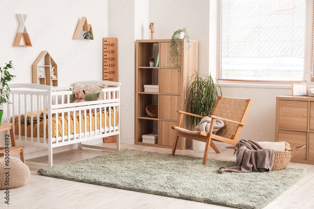 Interior of childrens bedroom with crib, shelves and toys