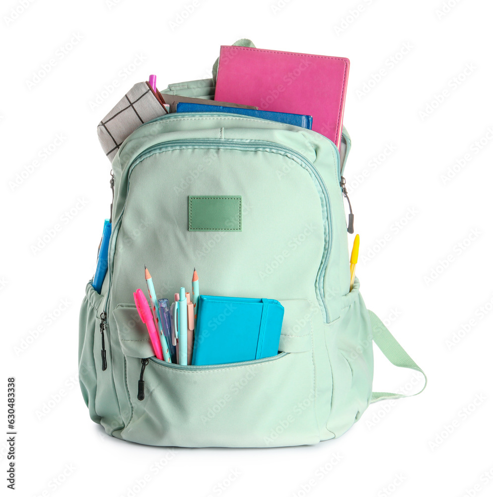 Green school backpack with notebooks, pencils case and pens on white background