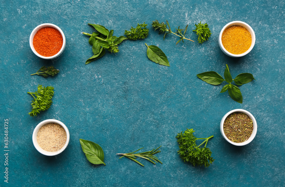 Frame made of fresh herbs and spices on color background
