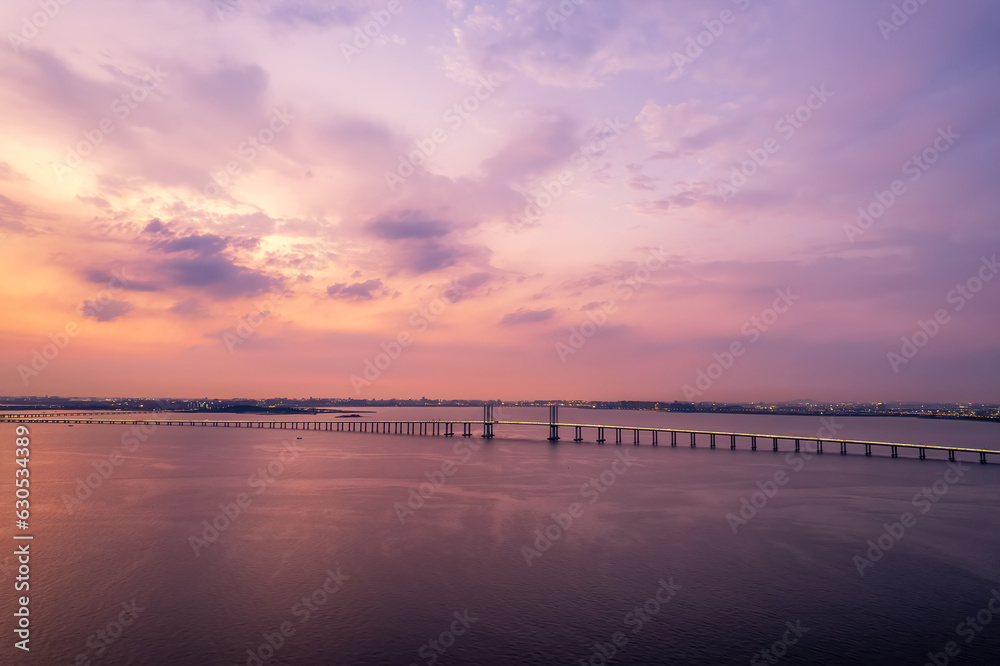 Aerial photo of Qingdao Jiaozhou Bay Cross Sea Bridge under sunset..