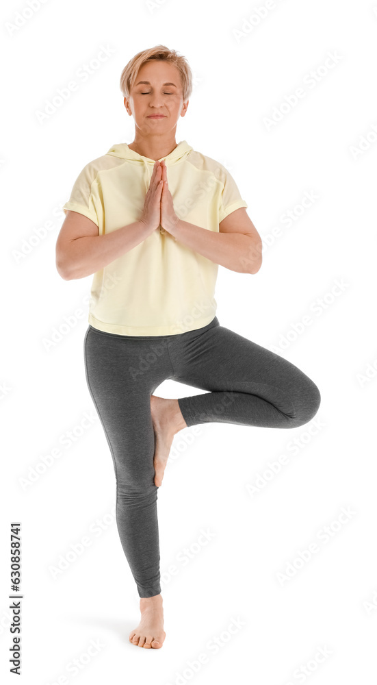 Sporty mature woman practicing yoga on white background