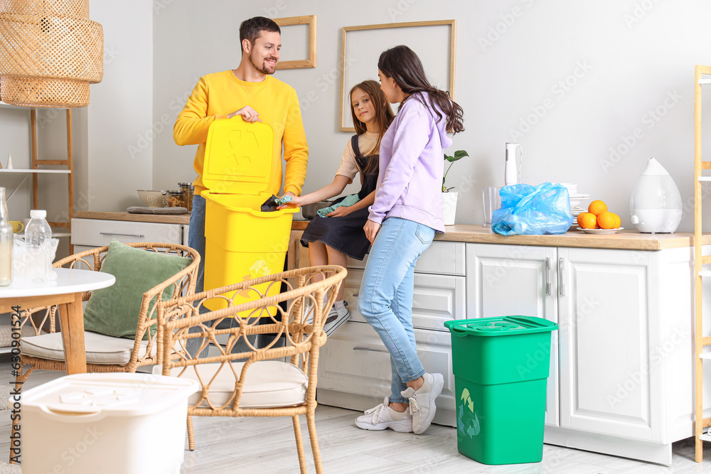 Family throwing paper garbage in recycle bin at home