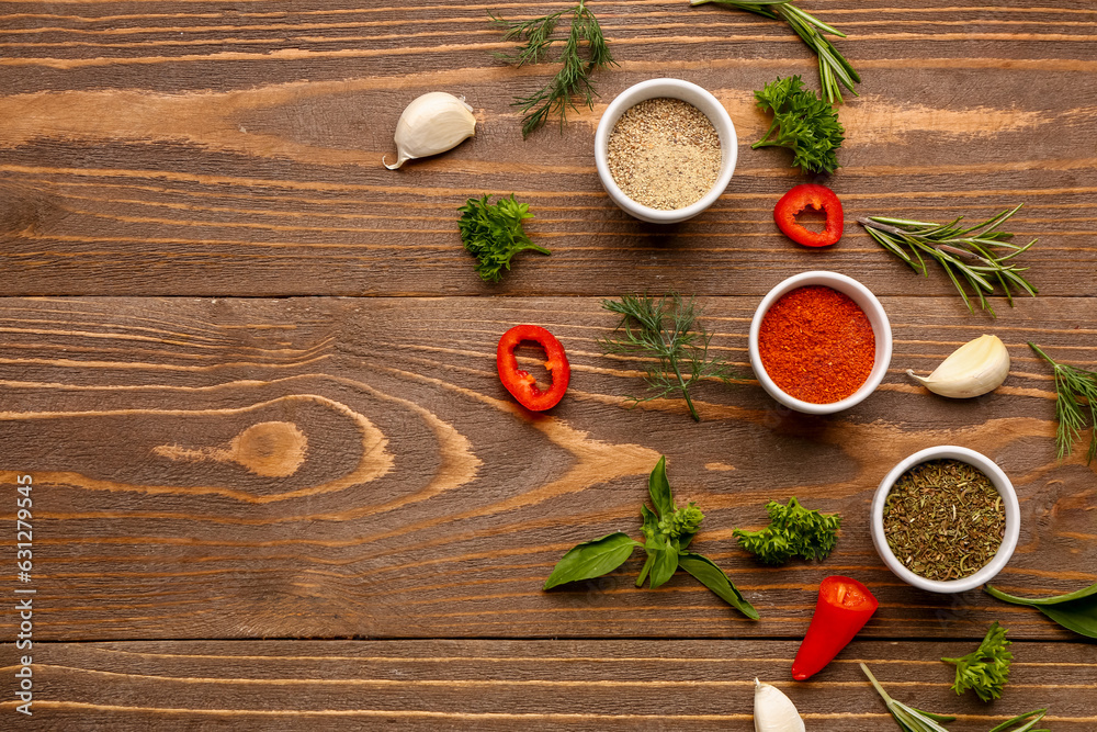 Composition with different spices and herbs on wooden background