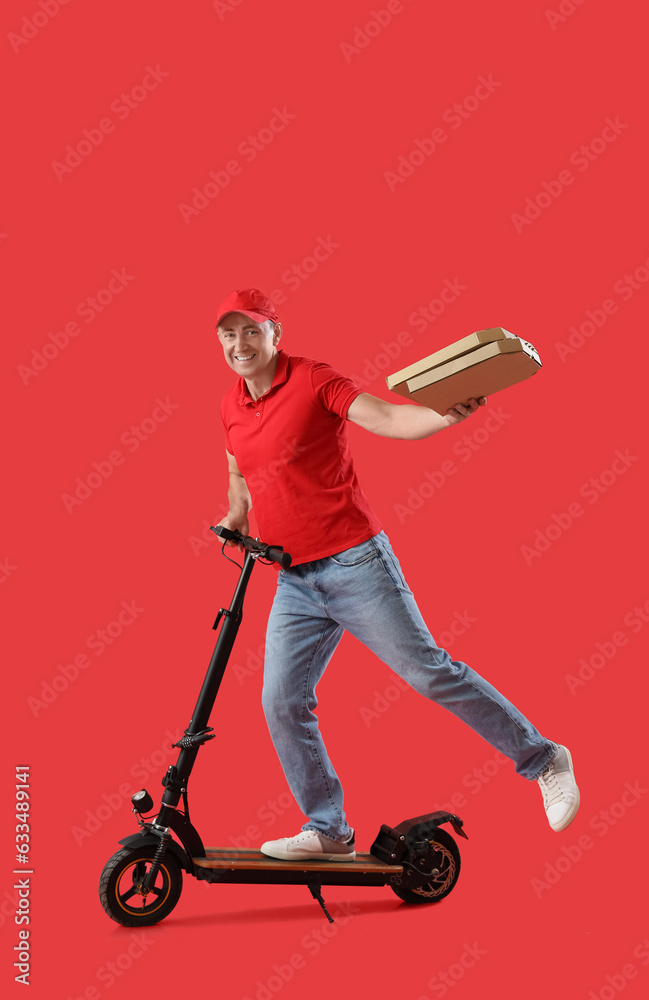 Mature courier with parcel and electric bike on red background
