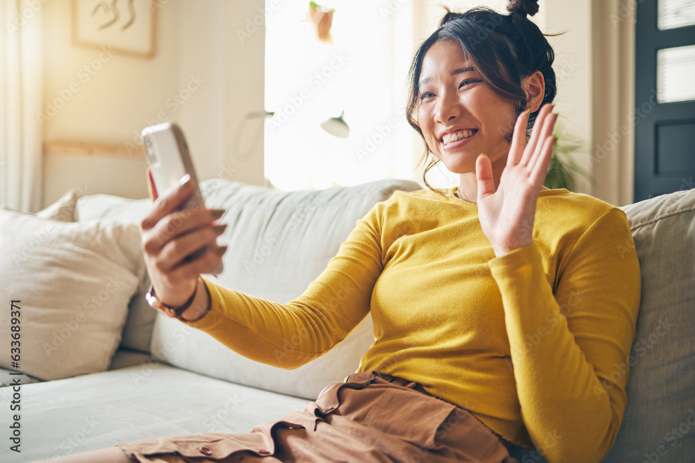 Phone, wave and Asian woman on video call on sofa, communication and conversation in living room. Sm