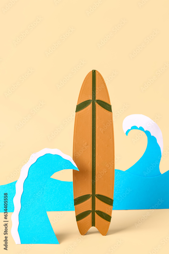 Creative composition with paper waves and mini surfboard on yellow background