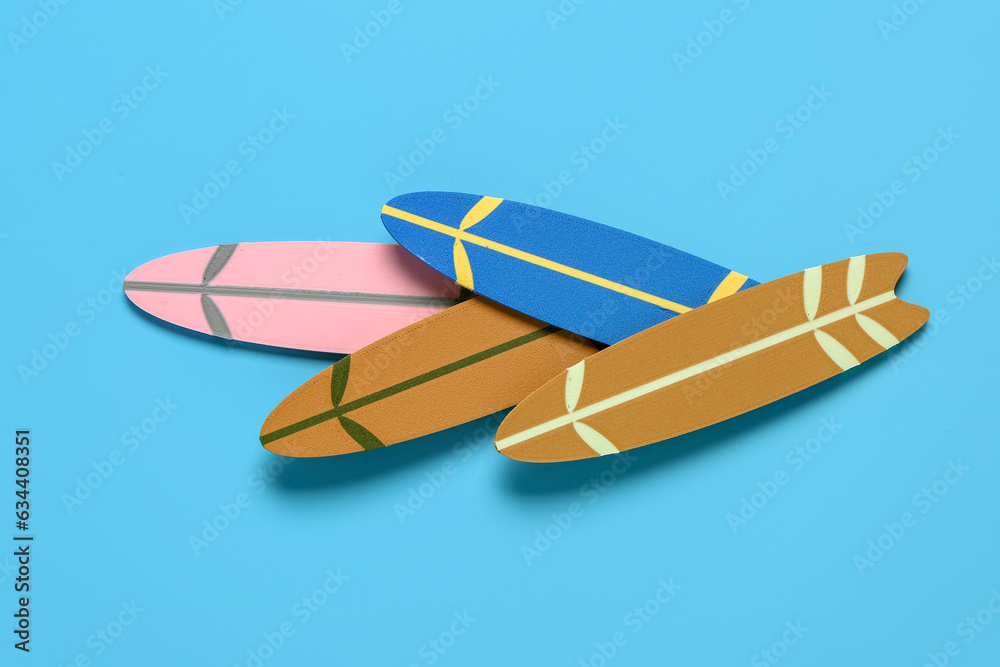 Different mini surfboards on blue background