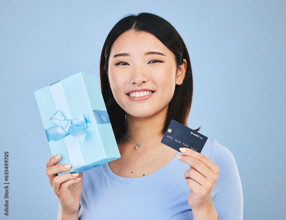 Woman, credit card and gift box, prize or retail giveaway and payment in portrait and a blue backgro