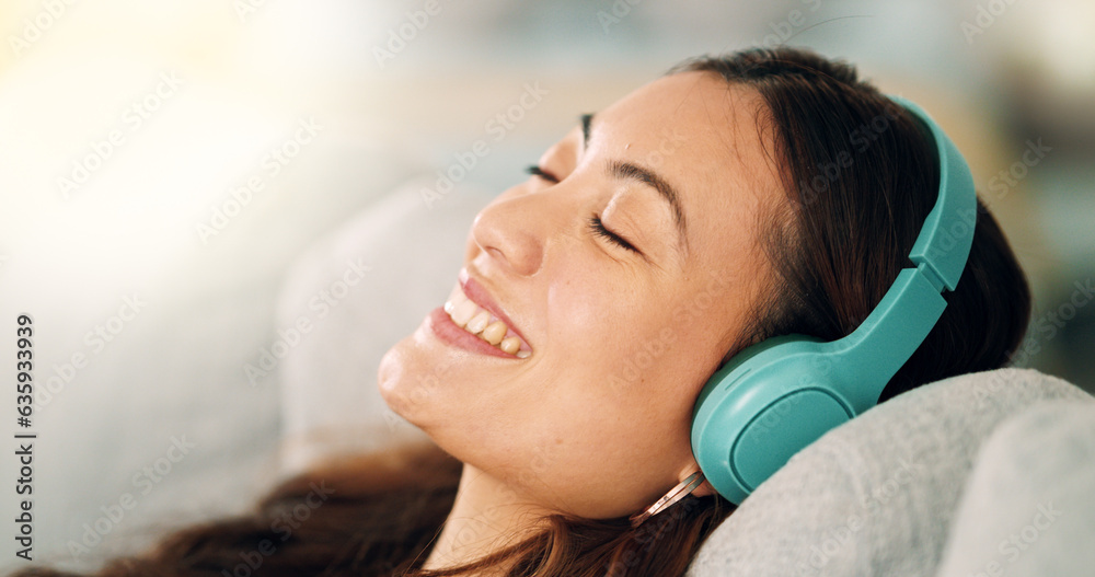 Relax, headphones and happy woman listening to music, radio or podcast while resting on sofa. Happin