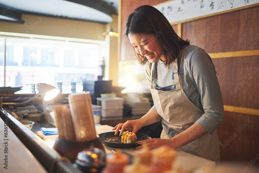 Sushi, restaurant worker and woman with smile from food and Asian meal in a kitchen. Happy, female w