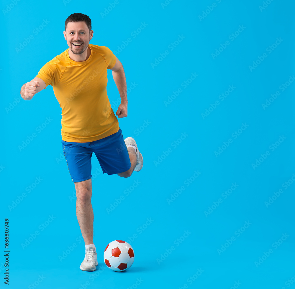 Man playing soccer on blue background
