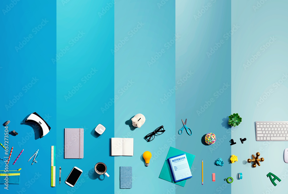 Collection of electronic gadgets and office supplies - flat lay