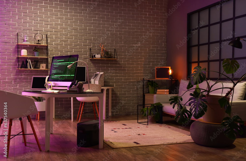 Interior of dark office with programmers workplaces
