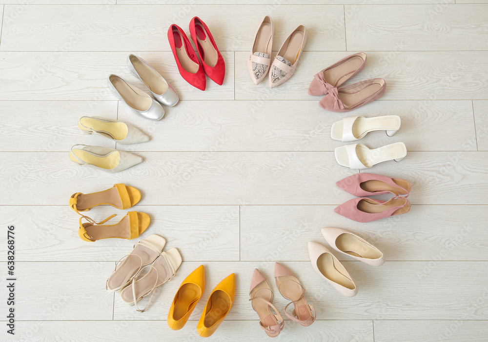 Frame made of different female shoes on light floor