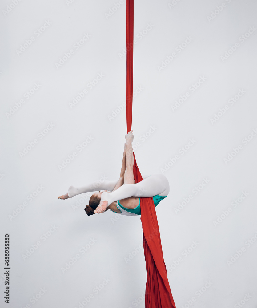 Gymnastics, acrobat and aerial silk with a woman in air for performance, sports and balance. Young a