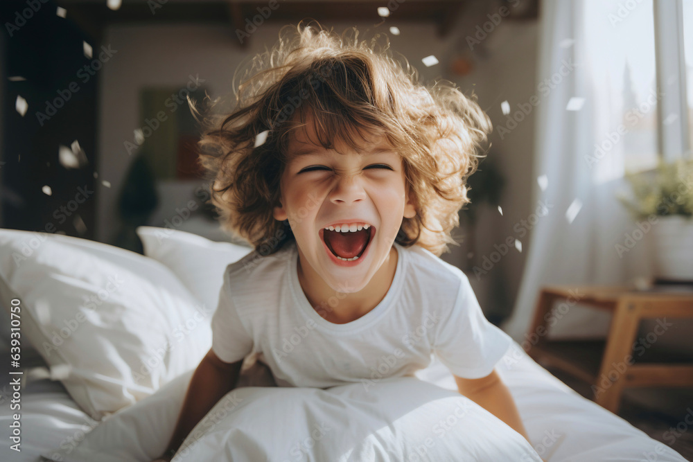 Happy little boy laughing playing on the bed at home - Generative AI