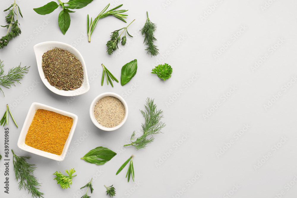 Composition with different herbs and spices on light background
