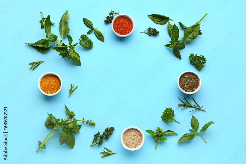 Frame made of fresh aromatic spices and herbs on color background