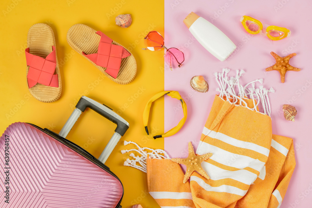 Composition with different beach accessories and suitcase on color background