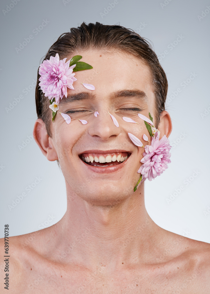 Happy, skincare and flowers on face of man in studio for spring, natural cosmetics and creative. Glo
